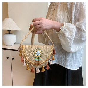 Close-up of bohemian straw bag with colorful tassels and intricate beadwork detail