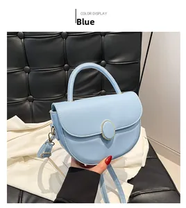 Close-up of blue saddle bag showing smooth leather texture and golden metal buckle