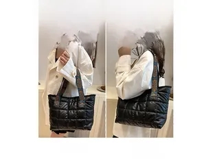 Detailed view of black quilted tote bag with vintage jacquard woven shoulder straps