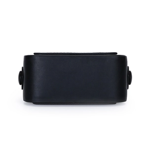 Macro view of the smooth leather texture and structured bottom of this black handbag