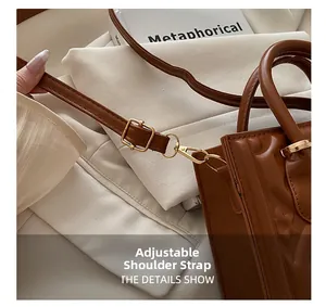 Detail of adjustable shoulder strap with gold buckle on floral embossed leather handbag