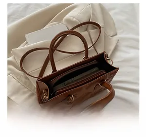 Detail view showing the spacious interior compartment of a brown quilted crossbody bag