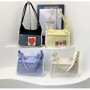 Details of colorful canvas and transparent PVC tote bags with adjustable shoulder straps