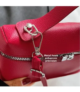 Dettaglio borsa in pelle rossa con trama litchi, gancio e cerniera in metallo argento