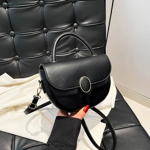 Vintage black leather half-moon saddle bag with golden buckle and top handle