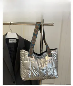Detail of silver quilted tote bag with bohemian style jacquard wide shoulder strap