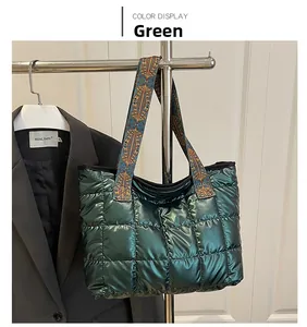 Close-up of quilted dark green tote bag with decorative ethnic geometric woven strap