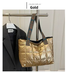 Detail of gold quilted tote bag with a wide geometric pattern ethnic shoulder strap