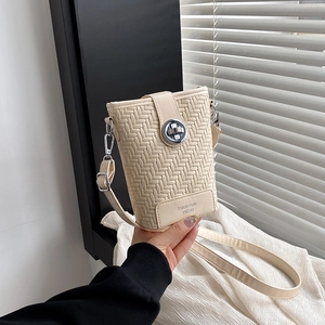 Beige woven bucket bag with silver rotating lock and shoulder strap for summer style