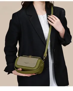Detail of army green and beige woven box bag showing adjustable thin shoulder strap