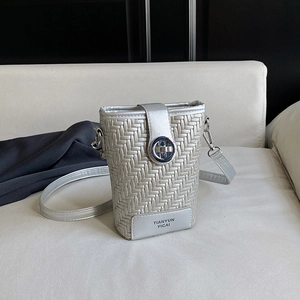 Silver woven bucket bag with metallic chain strap and circular metal clasp for women