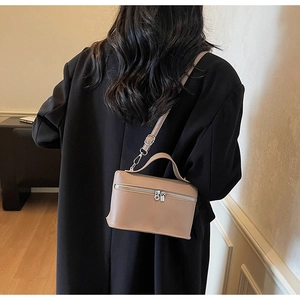Detailed back view of a khaki leather crossbody bag with top handle and strap