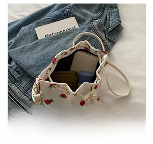 Interior view of floral drawstring bucket bag showing phone and wallet storage capacity