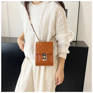 Close-up of brown quilted mini phone bag with golden twist lock and chain strap detail