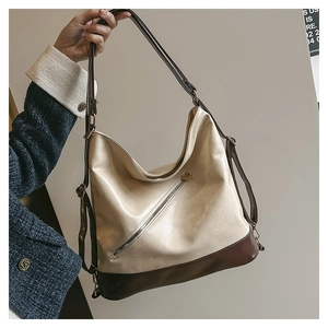 Detail of large vintage tote bag featuring contrast colors and unique diagonal metal zipper
