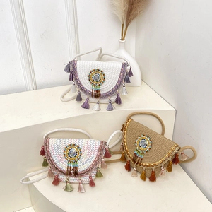 Bohemian woven straw bucket bag with colorful tassels and ethnic beaded details for women