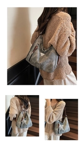 Detail view of large retro smoke gray tote bag with leather handles on models shoulder