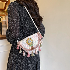 Bohemian hand-woven crossbody bucket bag with colorful tassels and ethnic beadwork