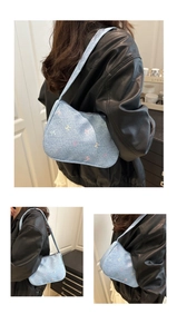 Detail of light blue denim shoulder bag featuring colorful embroidered bow patterns