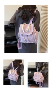 Detail of light purple backpack with embroidery, thick rope handle and decorative beads