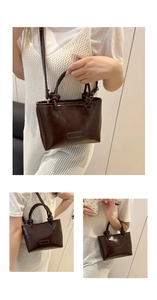 Detail view of coffee leather square bag with unique knotted handle and shoulder strap