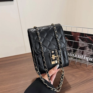 Minimalist black quilted crossbody bag for women with golden chain strap and twist lock