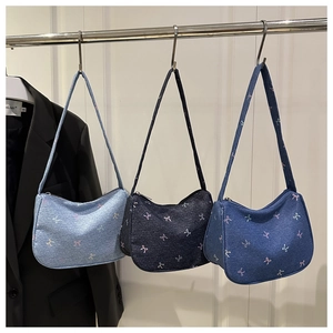 Detailed display of denim shoulder bags with colorful butterfly embroidery in three colors