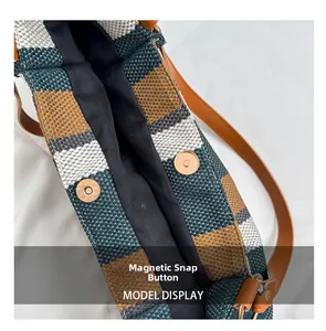 Detailed close-up showing the secure magnetic snap closure of this colorful woven tote bag