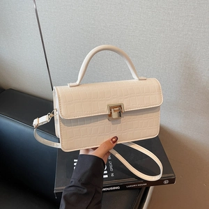 Chic off-white crocodile pattern handbag with gold clasp and adjustable shoulder strap