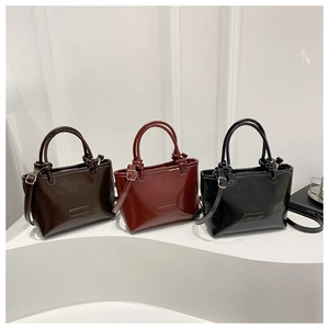 Three retro square crossbody bags in coffee, red, and black with knotted handles