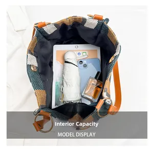 Spacious interior of striped canvas tote bag showing storage for tablet and essentials