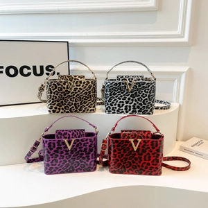 Chic leopard print crossbody bags in four colors with a metallic V-shaped buckle design