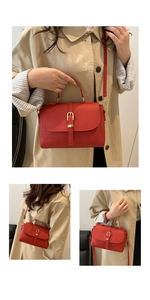Macro detail of red lychee texture leather with gold horseshoe lock on handbag