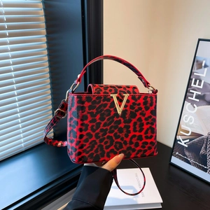 Fashionable red leopard print crossbody bag with gold V hardware and adjustable strap