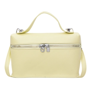 Minimalist light yellow pebble leather box bag with silver zippers and shoulder strap