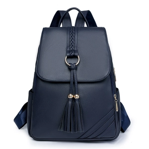 Dark blue pebbled leather backpack with tassel charms and golden ring front flap design
