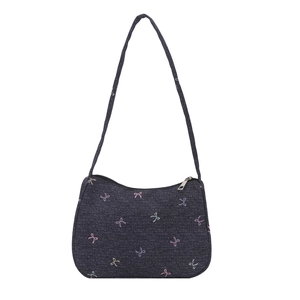 Deep blue denim shoulder bag with colorful bow patterns and slim strap on white background