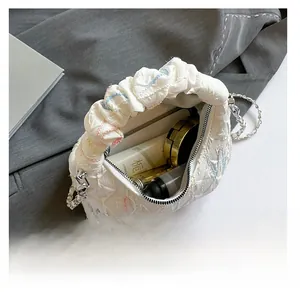 Detail view of the quilted texture bag showing spacious interior with cosmetic items