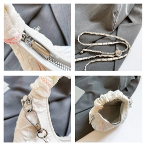 Detail view of white quilted bag featuring pastel stitching and silver chain strap