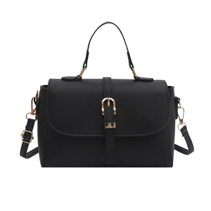 Black litchi grain leather handbag with gold hardware and adjustable strap on white background