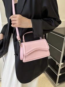 Pink PU leather crossbody bag with wave-edge flap and golden metal hardware