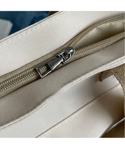 Detail of silver smooth metal zipper and premium canvas texture on tote bag