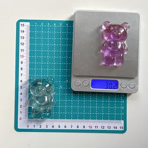 Close-up of bear phone grips with gold foil flakes on a scale showing 30.2g weight