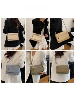 Detail view of stylish small crossbody bags in beige, yellow, blue grey and olive green
