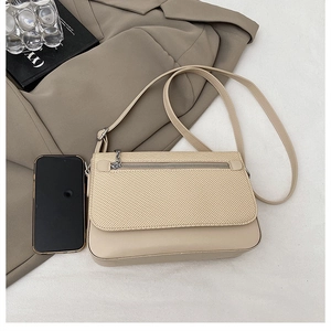 Detailed top view of beige flap crossbody bag showing its interior capacity with a smartphone