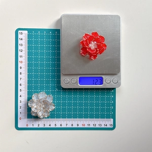 3D floral phone socket grips in red and white colors with gold edges and bead centers
