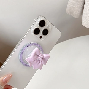 Close-up of lavender bow magnetic phone socket with Gift For You text on white iPhone