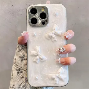 Detail of white sparkling iPhone case with 3D bows, pearls and silver metal lens frame