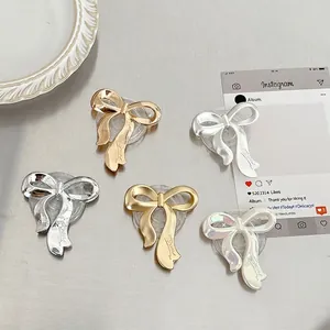 Collage of five colorful bow-shaped collapsible phone grips with transparent round bases