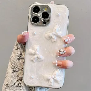 Detail of pearlescent iPhone case featuring 3D resin bows and scattered pearl accents